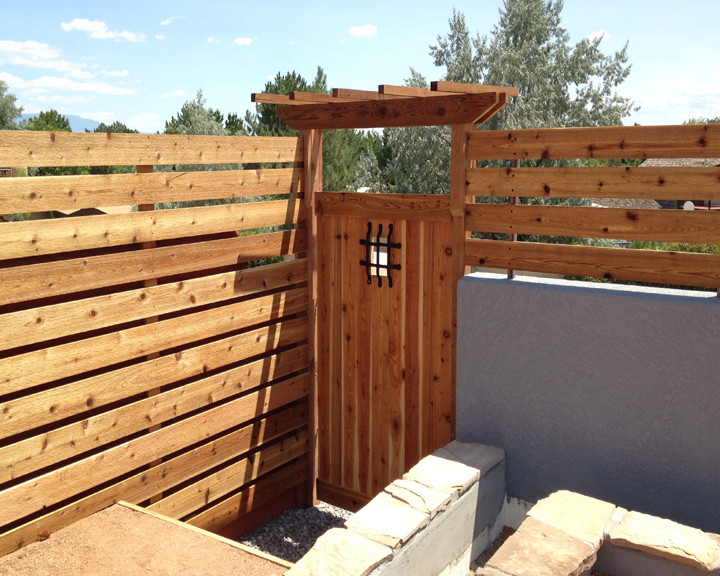 Design ideas for a mid-sized rustic full sun backyard landscaping in Denver for summer.
