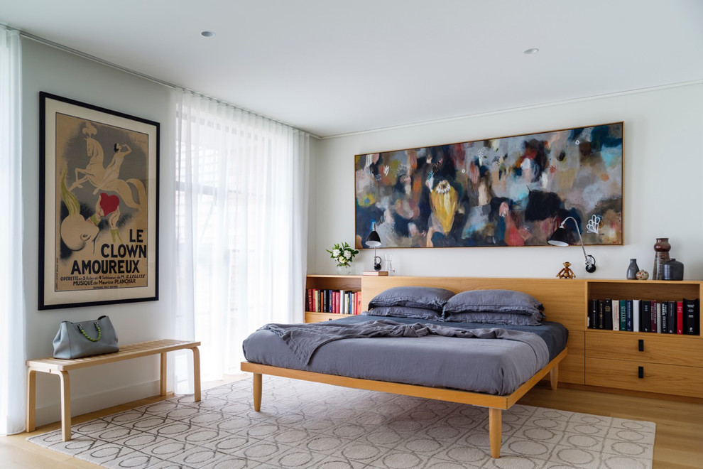 Photo of a large contemporary master bedroom in Sydney with white walls and light hardwood floors.