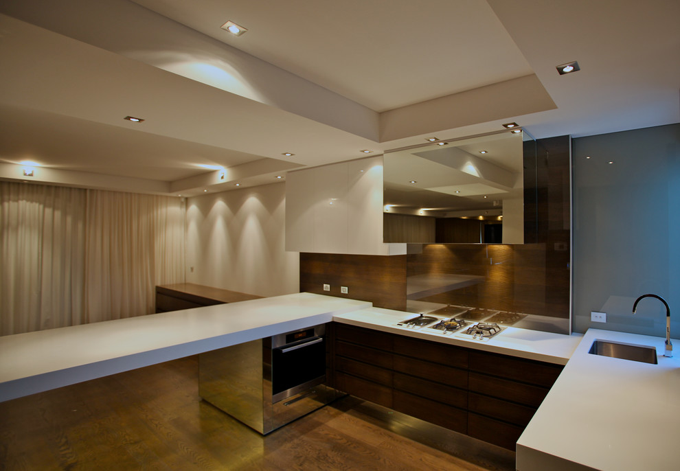 Open concept kitchen - transitional u-shaped dark wood floor open concept kitchen idea in Perth with an undermount sink, flat-panel cabinets, dark wood cabinets, granite countertops, glass sheet backsplash and no island