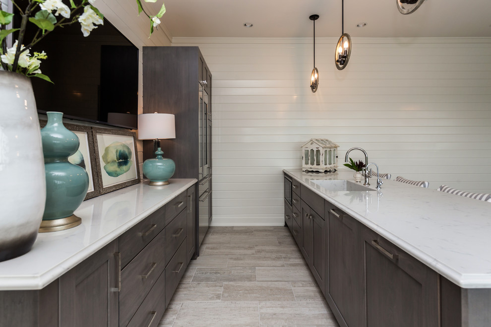 Photo of a transitional u-shaped home bar in Other with grey cabinets, marble benchtops, painted wood floors, white benchtop and shaker cabinets.