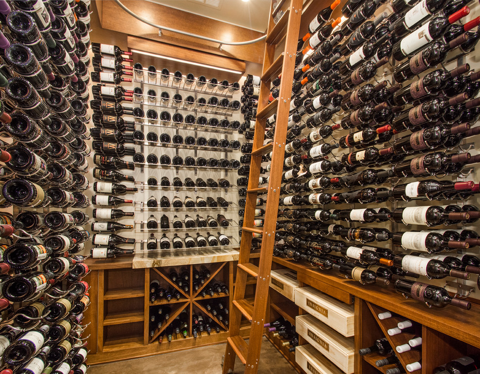 Inspiration for a large transitional concrete floor wine cellar remodel in Dallas with storage racks