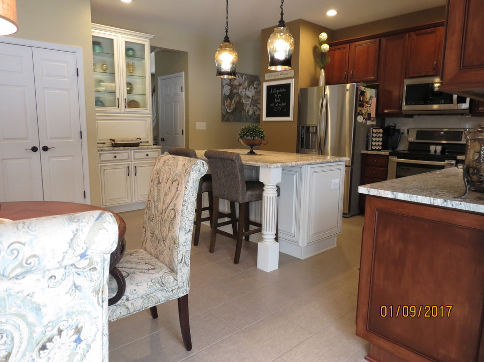 Mid-sized transitional l-shaped ceramic tile eat-in kitchen photo with an undermount sink, raised-panel cabinets, distressed cabinets, granite countertops, white backsplash, porcelain backsplash, stainless steel appliances and an island