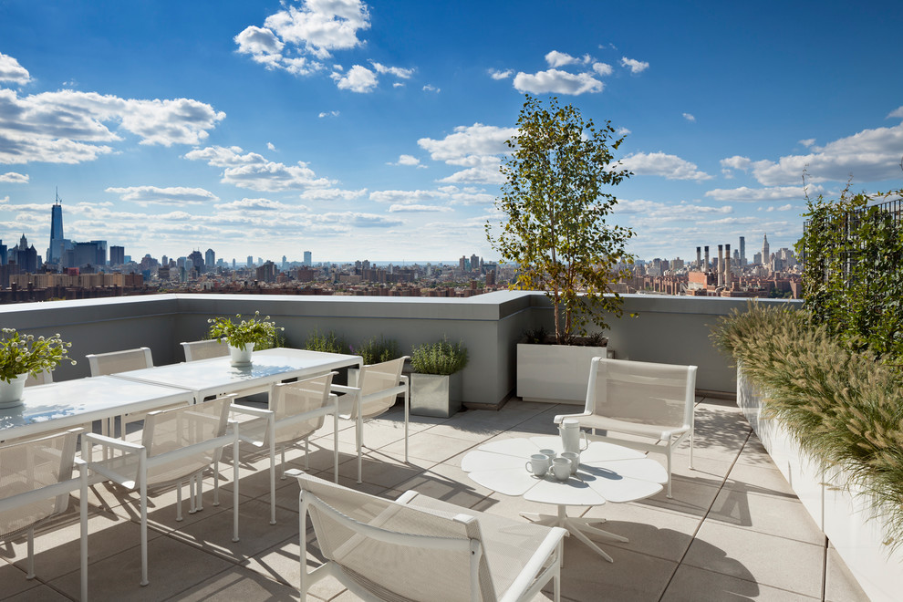 This is an example of a large modern rooftop deck in New York with no cover.