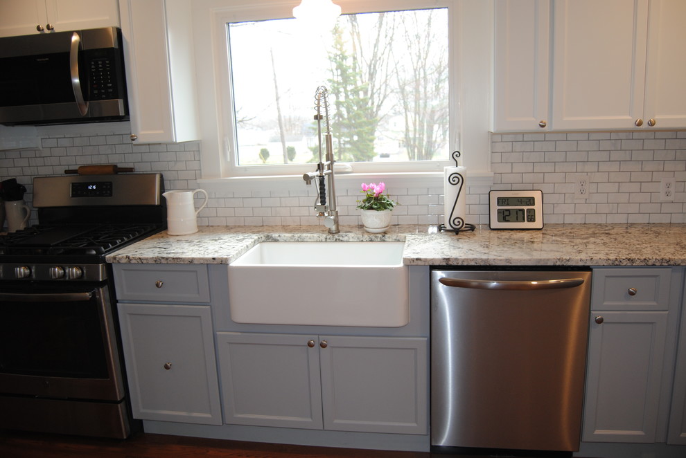 This is an example of a kitchen in New York with shaker cabinets and granite benchtops.