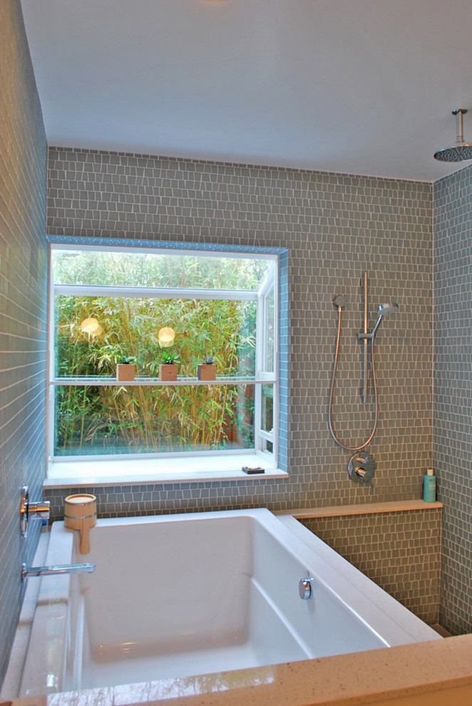 Inspiration for a contemporary bathroom in San Francisco with a japanese tub, green tile and mosaic tile.