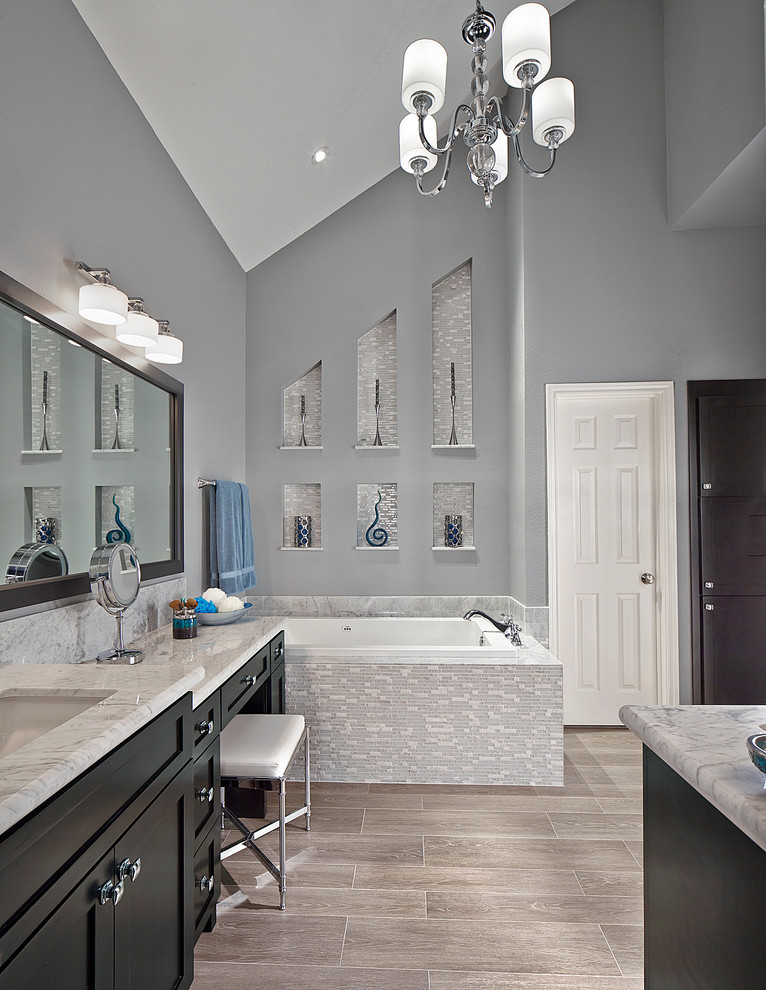 This is an example of a transitional bathroom in Dallas with an alcove tub.