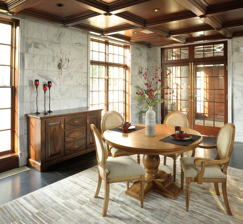 Design ideas for a large traditional kitchen/dining combo in Boston with grey walls, ceramic floors, no fireplace and black floor.