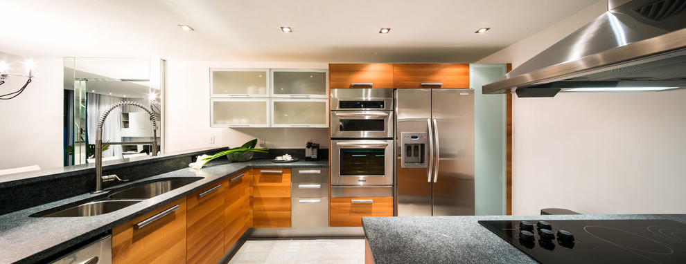 Modern l-shaped kitchen pantry in Miami with a double-bowl sink, medium wood cabinets, granite benchtops, white splashback, stainless steel appliances, porcelain floors and multiple islands.