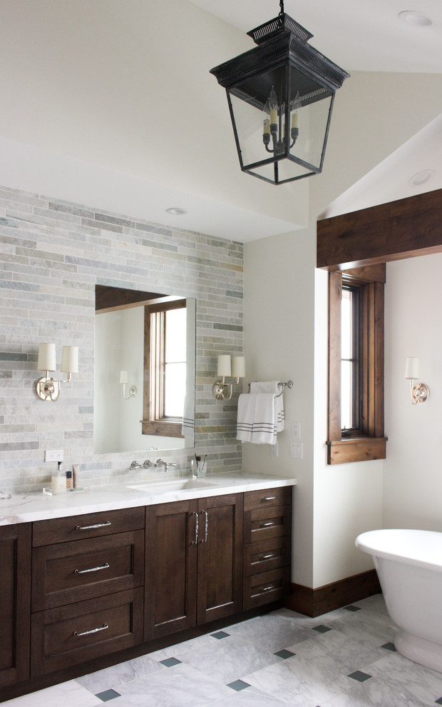 This is an example of a country master bathroom in Salt Lake City with shaker cabinets, dark wood cabinets, a freestanding tub, multi-coloured tile, white walls, an undermount sink, multi-coloured floor and white benchtops.