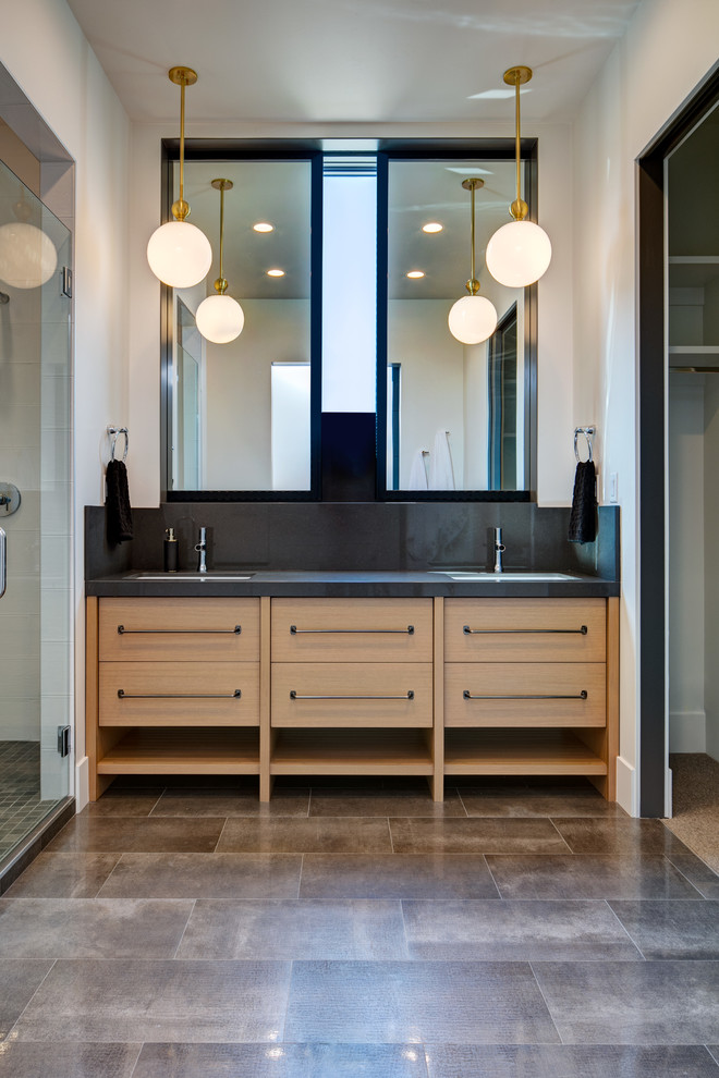 This is an example of a large country 3/4 bathroom in Salt Lake City with flat-panel cabinets, white cabinets, a freestanding tub, a corner shower, a one-piece toilet, multi-coloured tile, marble, white walls, slate floors, a vessel sink, engineered quartz benchtops, grey floor and black benchtops.