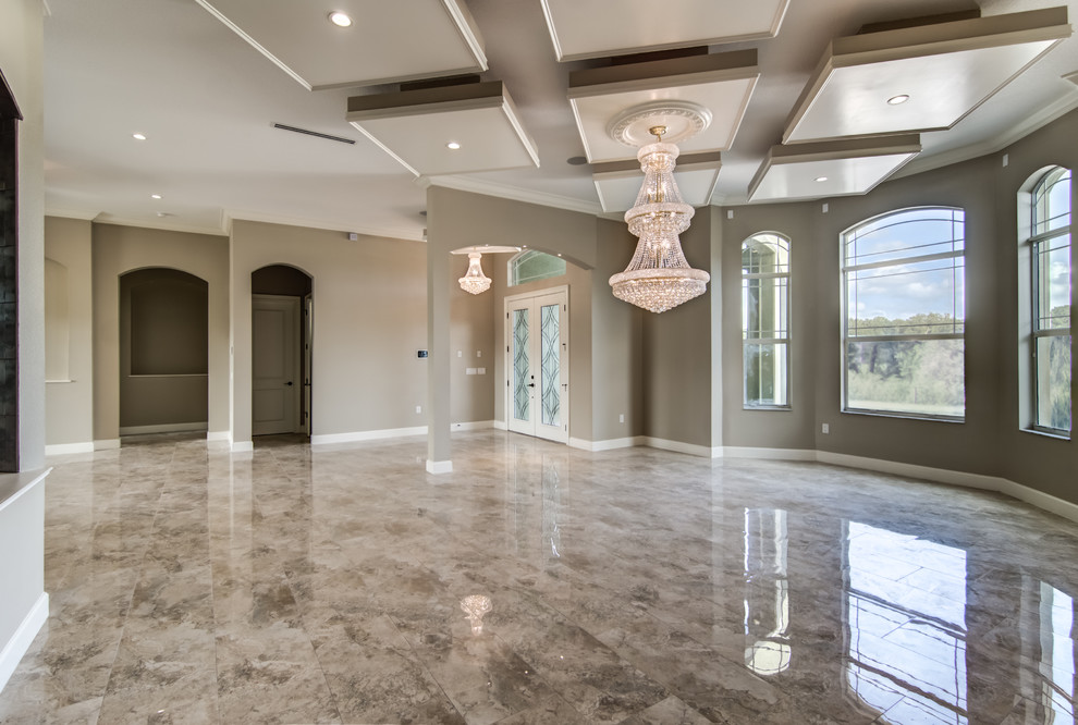 Photo of a large transitional open concept living room in Tampa with beige walls and marble floors.