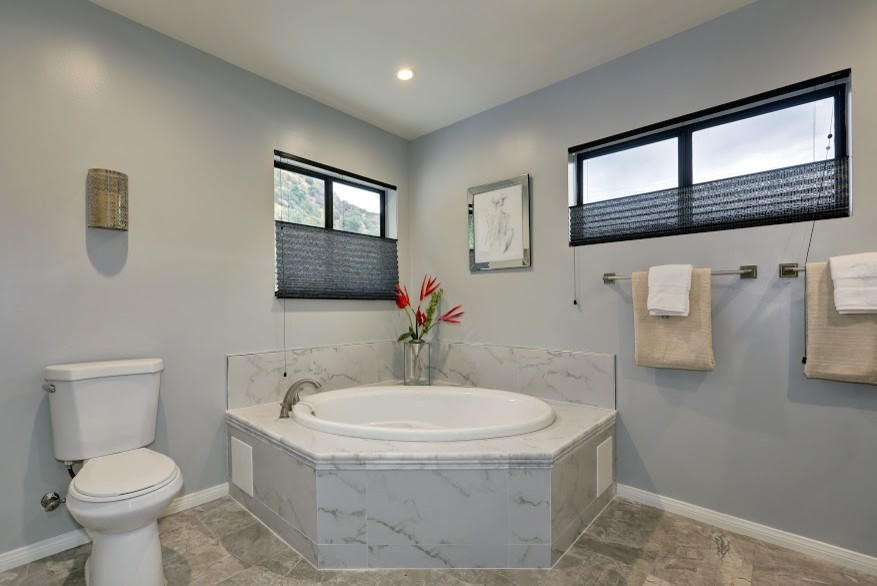 Large contemporary master bathroom in Atlanta with a drop-in tub and a one-piece toilet.