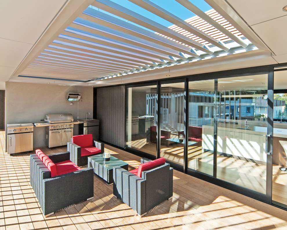 This is an example of a contemporary backyard patio in Sydney with a roof extension.
