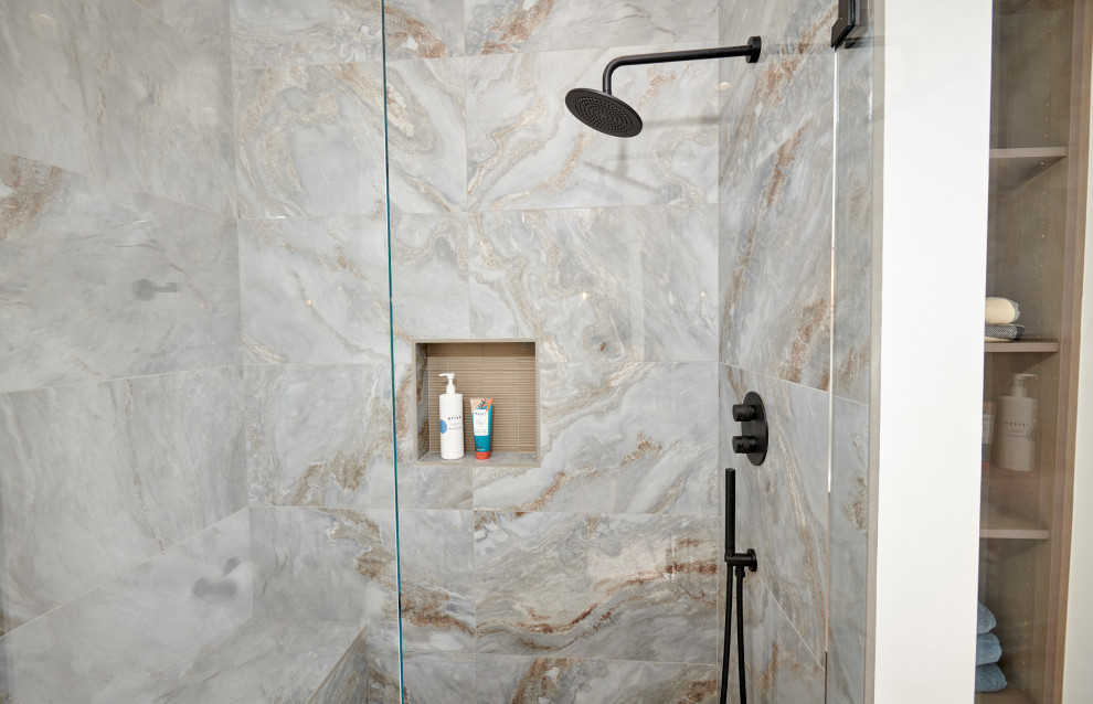 Example of a huge galley porcelain tile and brown floor open concept kitchen design in Denver with an undermount sink, recessed-panel cabinets, black cabinets, quartzite countertops, white backsplash, stone slab backsplash, stainless steel appliances, an island and white countertops