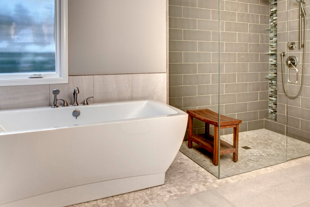 Example of a large transitional master multicolored tile and matchstick tile pebble tile floor freestanding bathtub design in Seattle with shaker cabinets, dark wood cabinets, a two-piece toilet, beige walls, an undermount sink and quartz countertops