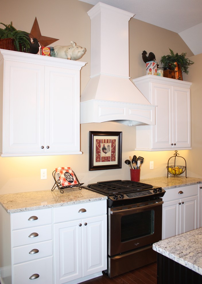 Inspiration for a transitional kitchen remodel in Minneapolis with a farmhouse sink, white cabinets, stainless steel appliances and an island