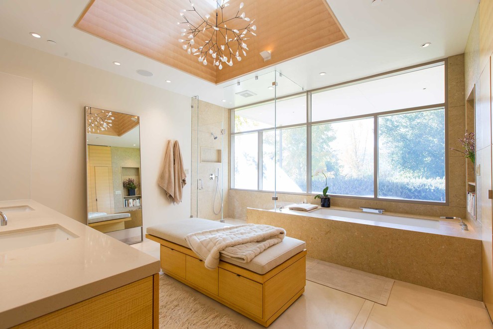 Inspiration for a midcentury bathroom in San Francisco with medium wood cabinets, an undermount tub, a corner shower, beige tile, beige walls, an undermount sink, beige floor and a hinged shower door.