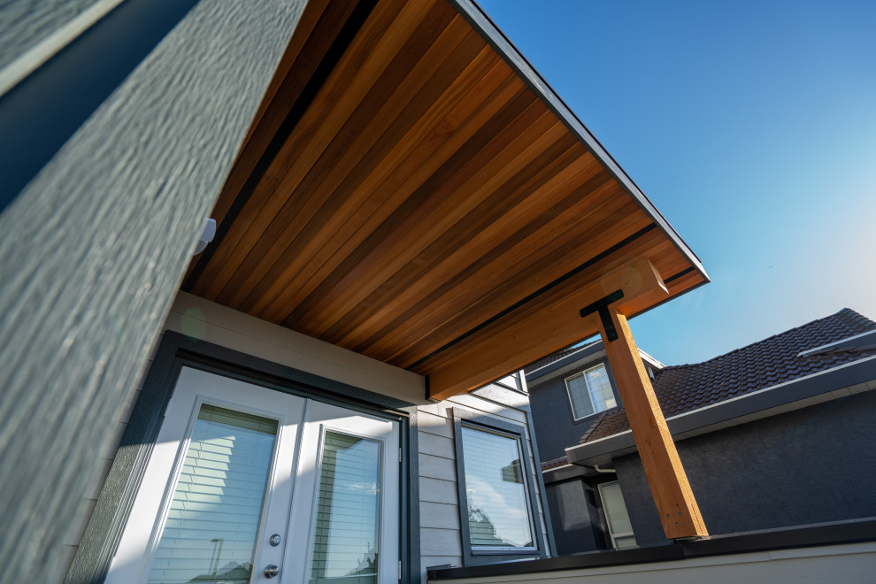 Design ideas for a mid-sized contemporary three-storey exterior in Vancouver with mixed siding.