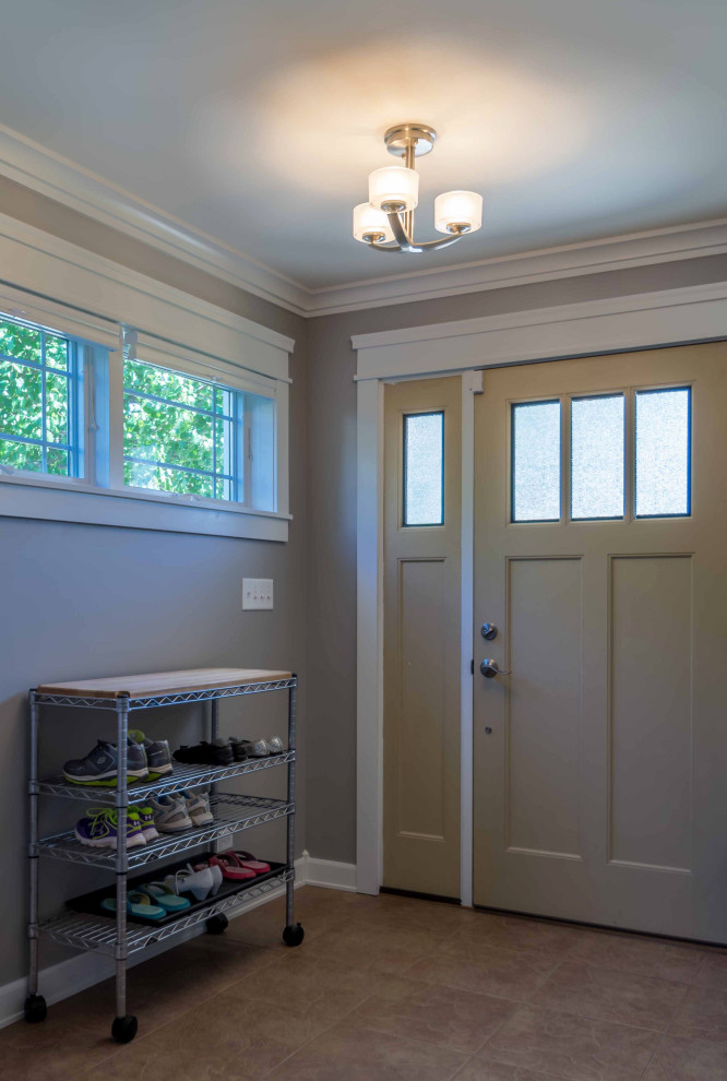 Mid-sized transitional mudroom in Chicago with grey walls, ceramic floors, a single front door, a brown front door, brown floor, wallpaper and decorative wall panelling.