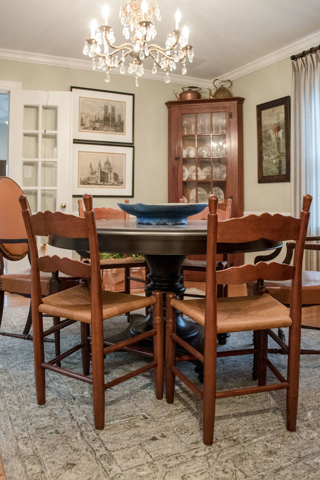 This is an example of a mid-sized eclectic separate dining room in Louisville with beige walls, medium hardwood floors and orange floor.