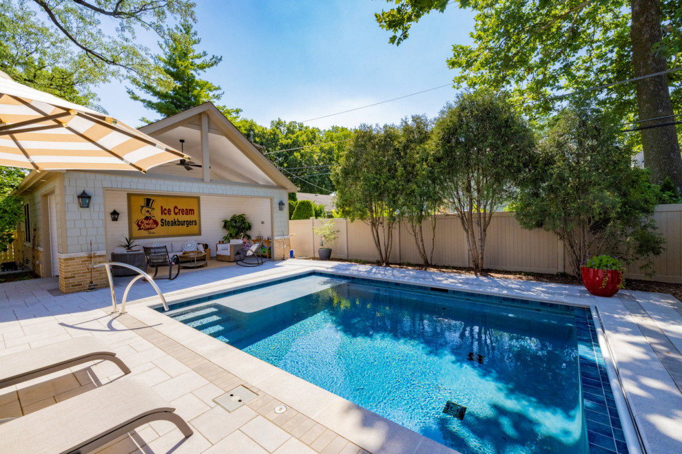 Inspiration for a small timeless backyard stone and rectangular pool house remodel in Chicago