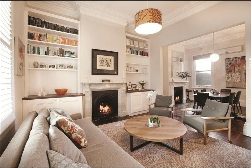 Mid-sized traditional formal open concept living room in Melbourne with white walls, dark hardwood floors, a standard fireplace, a stone fireplace surround and no tv.