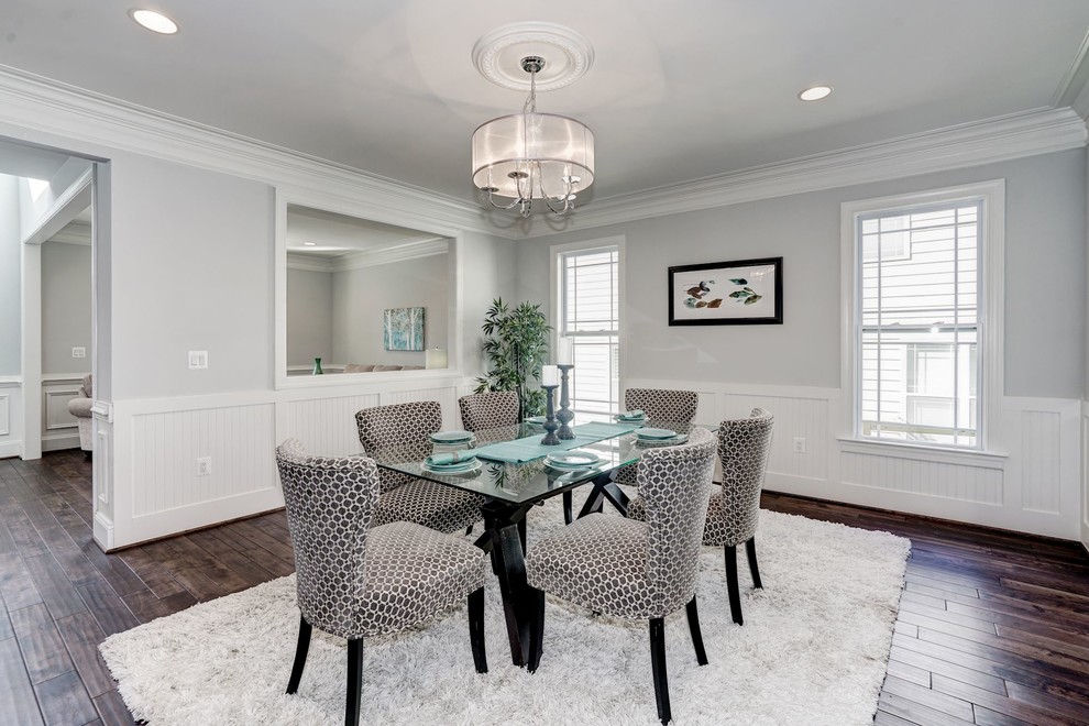 This is an example of a mid-sized transitional separate dining room in DC Metro with grey walls, dark hardwood floors, no fireplace and brown floor.