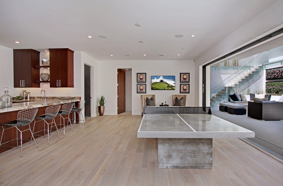 Inspiration for a contemporary family room in Orange County with white walls and light hardwood floors.