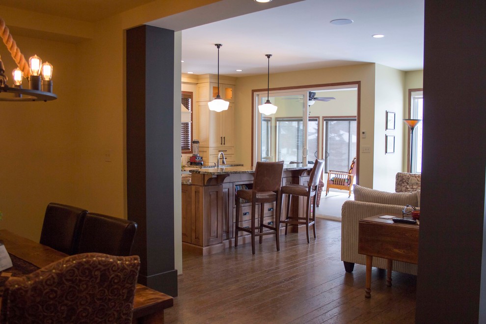 Example of a mid-sized transitional eat-in kitchen design with an undermount sink, recessed-panel cabinets, white cabinets, granite countertops, white backsplash, stainless steel appliances and an island