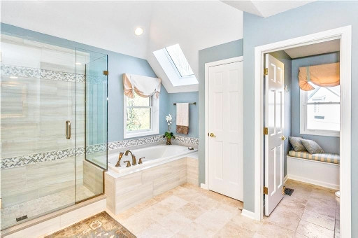 Large transitional master black tile, gray tile and mosaic tile porcelain tile and beige floor drop-in bathtub photo with raised-panel cabinets, white cabinets, gray walls, an undermount sink, quartz countertops, a hinged shower door and gray countertops