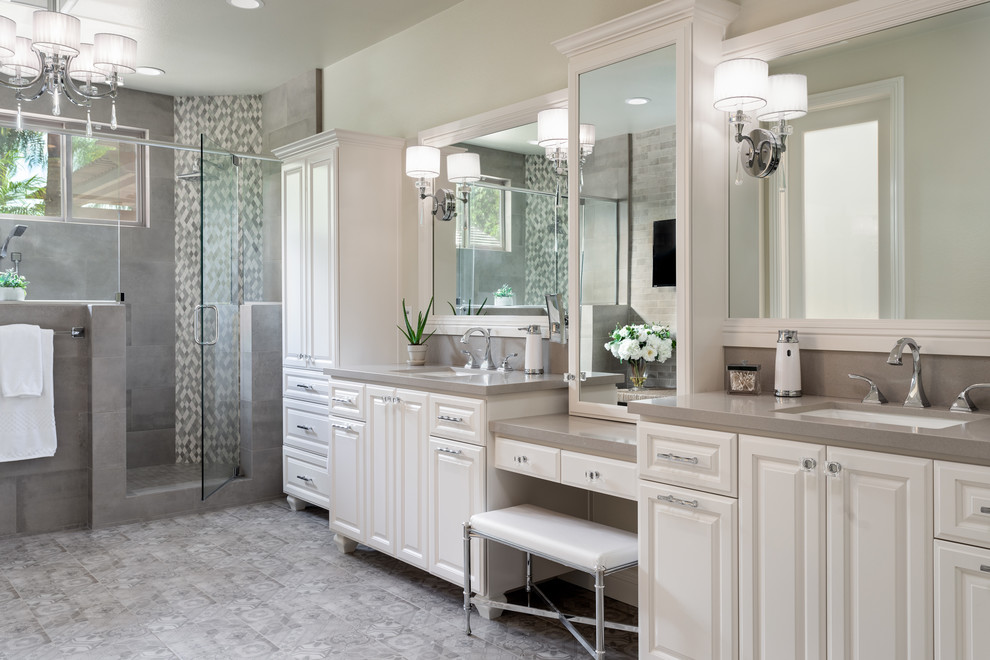 Transitional master bathroom in San Diego with raised-panel cabinets, white cabinets, an alcove shower, gray tile, grey walls, an undermount sink, grey floor, a hinged shower door and grey benchtops.