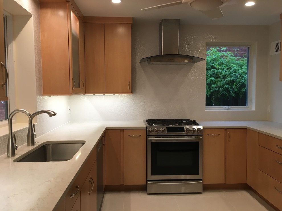 Example of a mid-sized transitional u-shaped porcelain tile and gray floor enclosed kitchen design in DC Metro with an undermount sink, flat-panel cabinets, medium tone wood cabinets, quartz countertops, white backsplash, porcelain backsplash, stainless steel appliances and no island