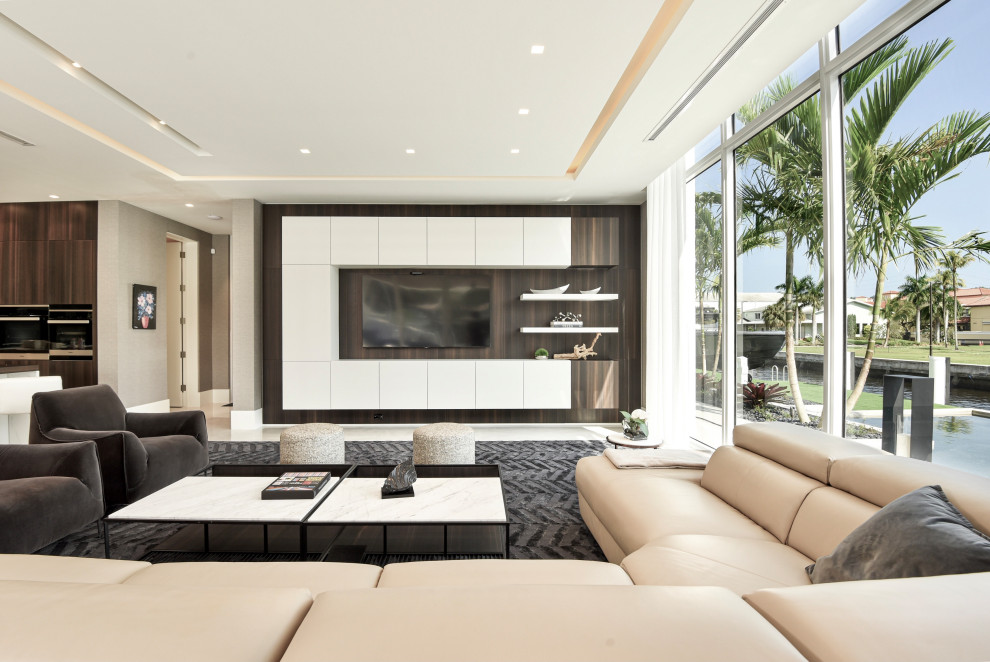 Large contemporary open concept family room in Miami with marble floors, a wall-mounted tv and wood walls.