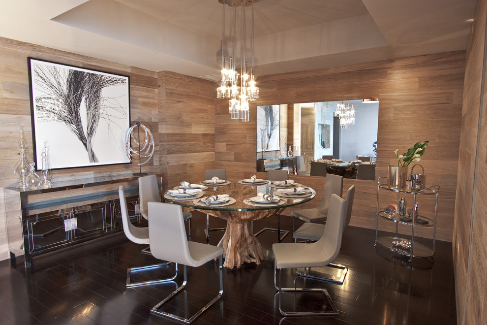 Modern dining room in Miami with dark hardwood floors.