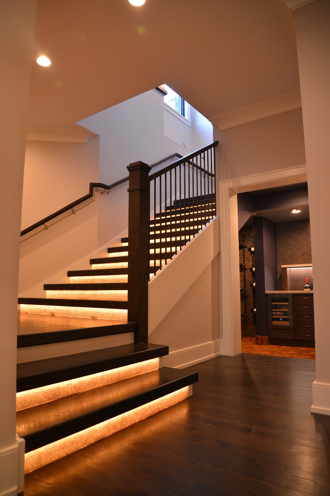 This is an example of an expansive wood u-shaped staircase in Chicago with glass risers.
