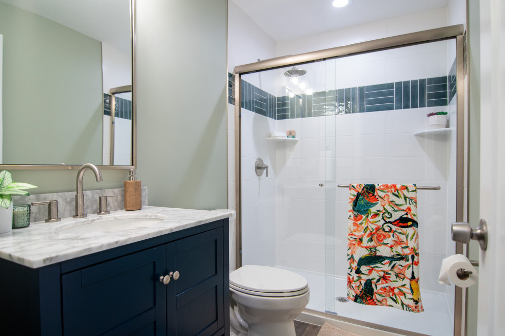 Large transitional 3/4 multicolored tile and porcelain tile vinyl floor, brown floor and single-sink bathroom photo in Other with shaker cabinets, blue cabinets, a one-piece toilet, beige walls, an undermount sink, quartz countertops, white countertops and a freestanding vanity