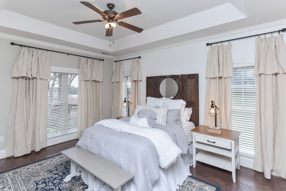 Photo of a large arts and crafts master bedroom in Other with grey walls, dark hardwood floors, brown floor and planked wall panelling.