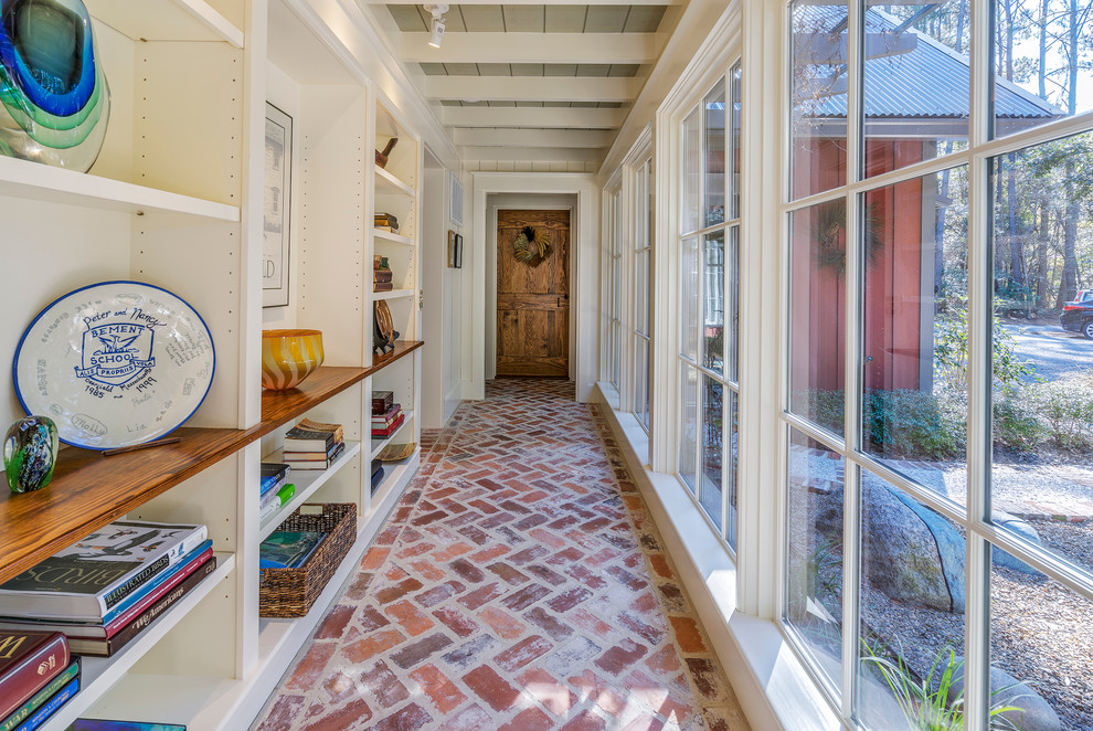 Photo of a country hallway in Atlanta with white walls, brick floors and red floor.