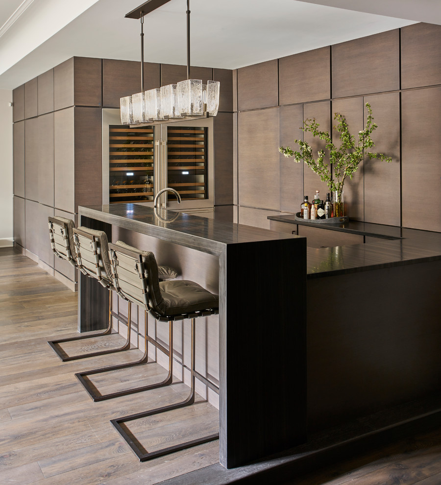 Inspiration for a contemporary medium tone wood floor seated home bar remodel in Chicago with flat-panel cabinets and brown cabinets