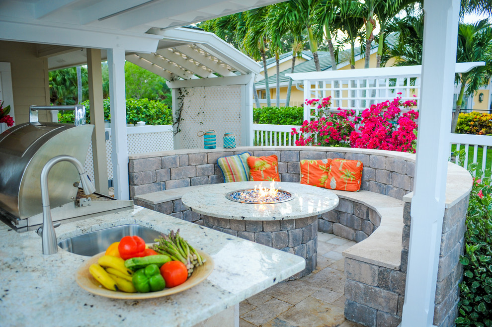 Mid-sized traditional backyard patio in Miami with concrete pavers.