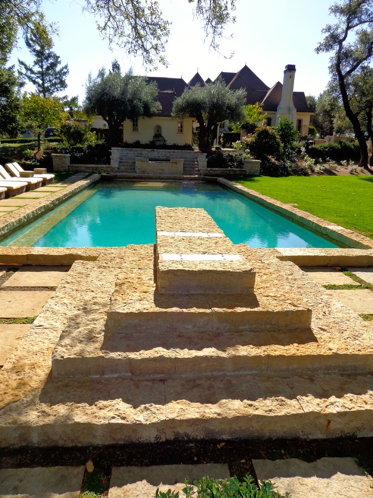 Inspiration for a large modern backyard rectangular lap pool in San Francisco with natural stone pavers.