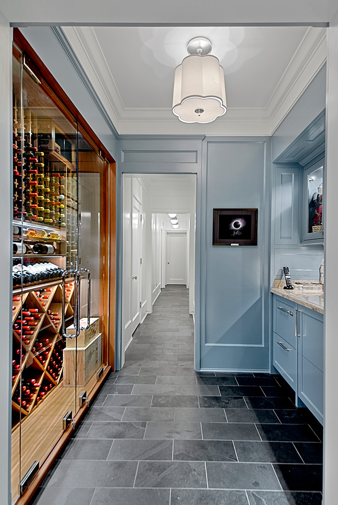 Small contemporary wine cellar in Chicago with slate floors, display racks and grey floor.