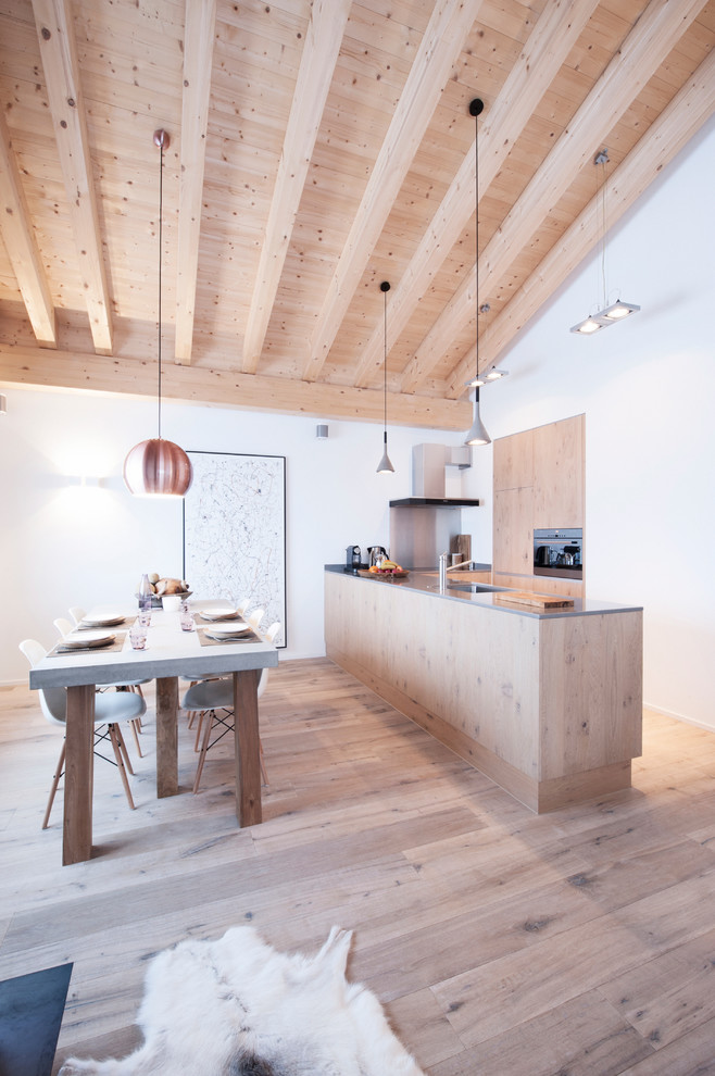 Inspiration for a small rustic l-shaped eat-in kitchen remodel in Amsterdam with flat-panel cabinets, light wood cabinets, concrete countertops, white backsplash and an island