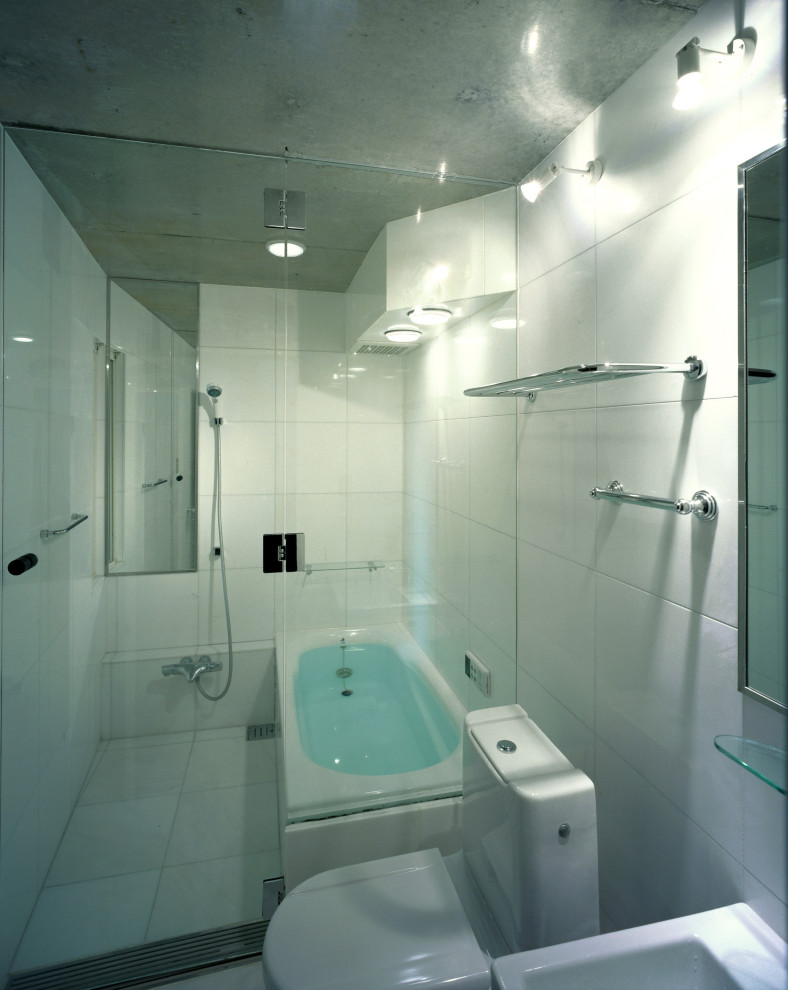 Inspiration for a mid-sized asian master bathroom with beaded inset cabinets, white cabinets, a drop-in tub, a shower/bathtub combo, a two-piece toilet, white tile, marble, white walls, marble floors, a vessel sink, solid surface benchtops, white floor, a hinged shower door and white benchtops.
