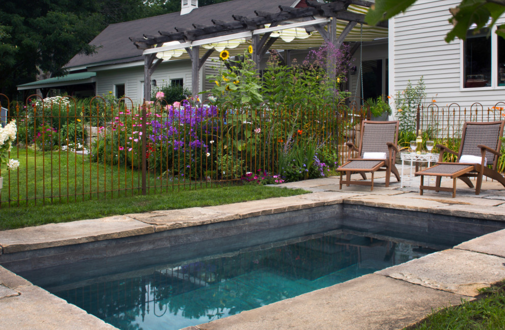 This is an example of a small country courtyard rectangular lap pool in Nashville with natural stone pavers.