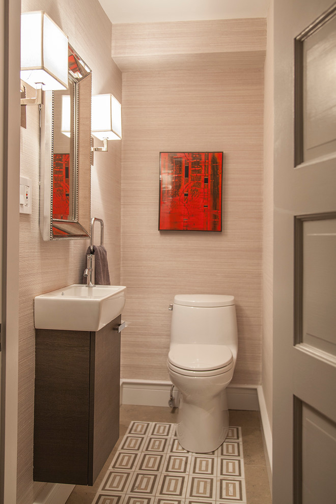 This is an example of a small modern powder room in Boston with a wall-mount sink, flat-panel cabinets, dark wood cabinets, a one-piece toilet, gray tile, stone tile, grey walls and limestone floors.