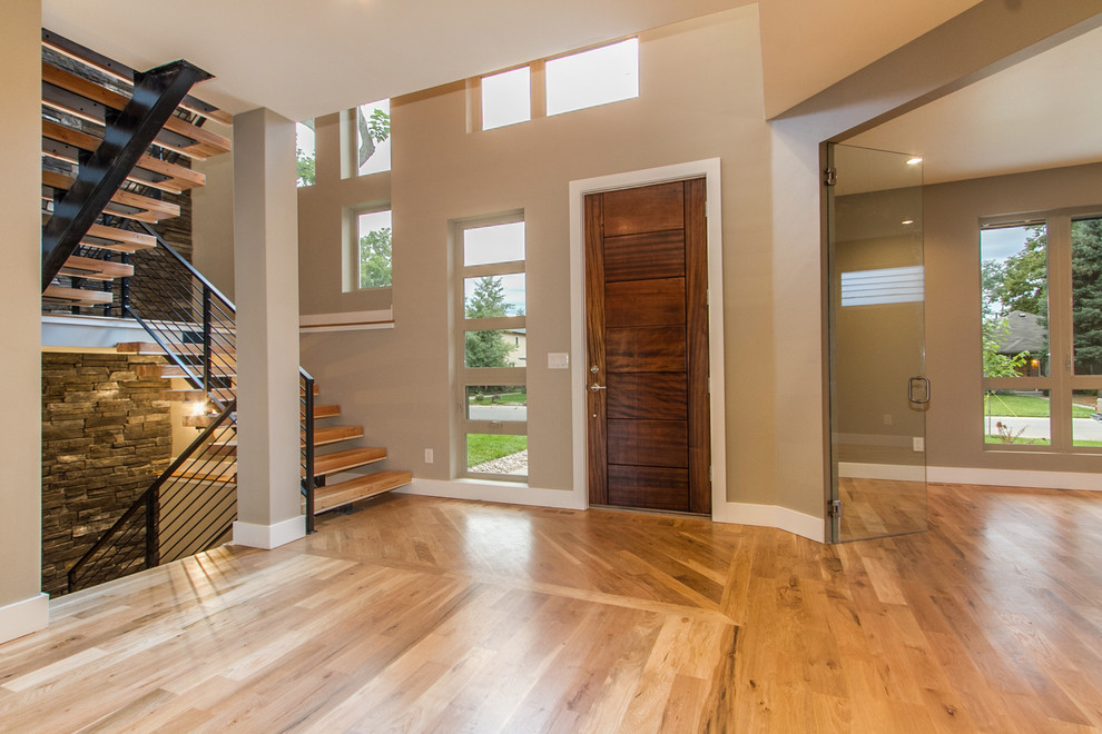 Mid-sized modern foyer in Denver with grey walls, light hardwood floors, a single front door and a brown front door.