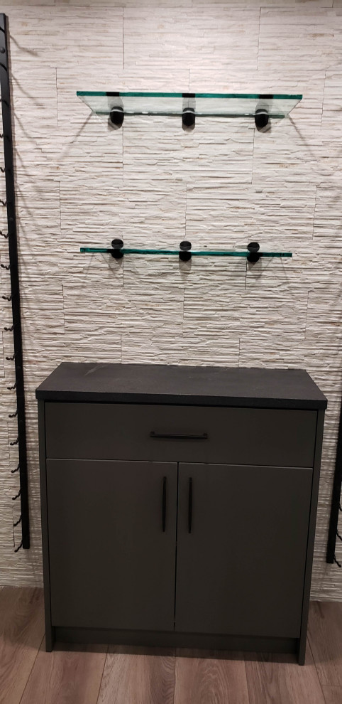 Example of a large transitional walk-out vinyl floor basement design with a bar
