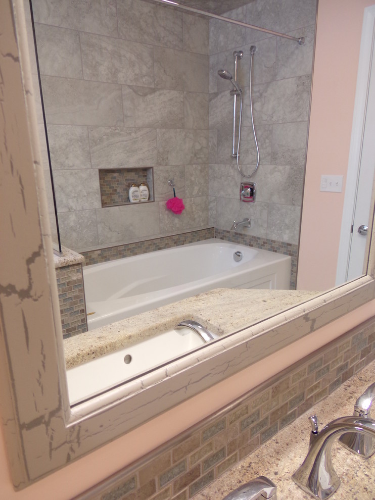 Alcove bathtub - mid-sized transitional kids' gray tile and porcelain tile porcelain tile alcove bathtub idea with an undermount sink, raised-panel cabinets, white cabinets, granite countertops and orange walls