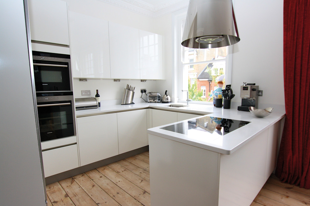 This is an example of a small contemporary u-shaped kitchen in London.